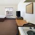 Woodspring Suites Asheville - Biltmore West guest room with bed, TV, desk and window in Asheville