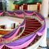 The Putra Regency Hotel in Kangar: curved lobby staircase with purple drapery and circular reception desk