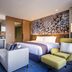 Novotel Suites Ambassador Seoul Yongsan suite with bed, seating area, and kitchenette in Seoul