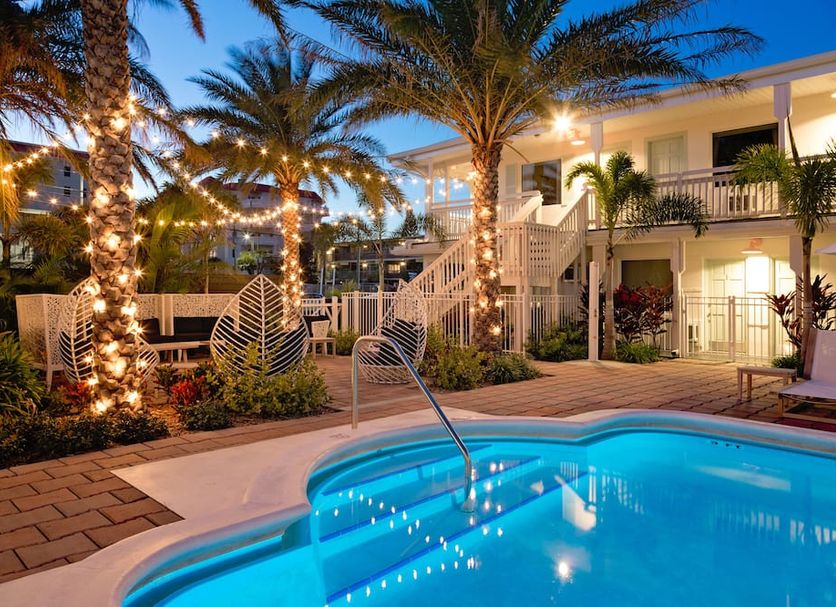 Hotel Cabana Clearwater Beach in Clearwater Beach with a lit palm-lined pool courtyard and outdoor seating