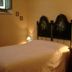 Agriturismo La Capitata room in Pian di Scò with double bed, bedside lamps and floral headboard