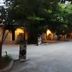 Bangrak Resort in Nakhon Sawan with a tree-lined driveway and warmly lit entrance walkway