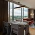 The Tess, Autograph Collection in Atlanta: suite with floor-to-ceiling windows, river view, and seating area