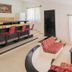 Villas del Sol Hotel & Bungalows in Oaxaca lobby with red patterned chairs, bar stools, and light-filled windows