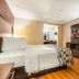 Red Roof Inn Phoenix-Midtown room with bed, desk, wall-mounted TV, and chair in Phoenix