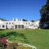 Pawleys Plantation Golf & Country Club in Pawleys Island, white clubhouse with manicured lawn and flower beds