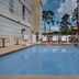 Home2 Suites by Hilton Lake City outdoor pool with lounge chairs and pergola