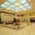 Zhongyuan Hotel in Anyang lobby with skylight ceiling, chandeliers, polished floors, and seating area