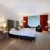 Van der Valk Hotel Hardegarijp - Leeuwarden room with king bed, seating area and wall-mounted TV in Hurdegaryp