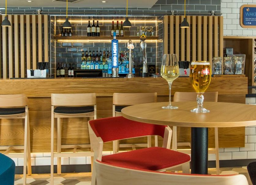 Holiday Inn Express Bristol City Centre bar area with stools, round table, and drinks in Bristol