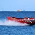 Coral Princess Hotel & Dive Resort in Cozumel with a red speedboat racing across the ocean