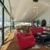 Chris Park Hotel lounge in Campos do Jordão with red chairs, sofas, arched openings and city views