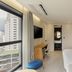 Hotel Londoner Gwanganlli room in Busan with large window, city view, bed and desk