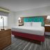Hampton Inn Yorkville room with king bed, desk, TV and lime green chair