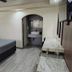 Hotel Siesta Real Mexicali room with bed, TV, vanity and arched bathroom doorway