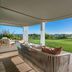 W Algarve in Albufeira terrace with sofa seating, lawn, and sunlit ocean view