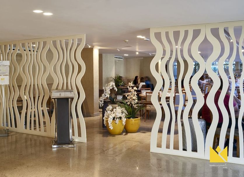 Brasília Imperial Hotel e Eventos lobby entrance with wavy divider panels and seating area in Brasilia