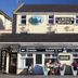 Lahinch Hostel in Lahinch, street view of hostel facade with outdoor café seating