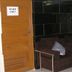 Ideal Hotel Pratunam in Bangkok lobby seating area with dark sofa and wooden doors
