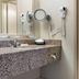Quality Hotel Conference Center Cincinnati Blue Ash bathroom with granite vanity, mirror, hair dryer and tub-shower