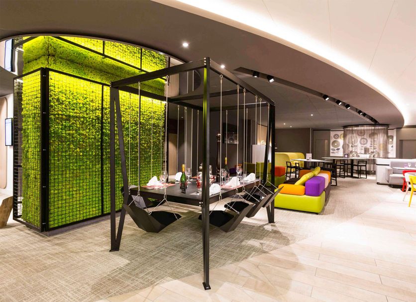 Novotel Resort & Spa Biarritz Anglet in Anglet, modern lounge with hanging chairs and colorful seating