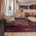 Courtyard by Marriott Fairfax Fair Oaks lobby lounge with purple rug, sectional seating and oval coffee table in Fairfax