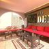 Villa Deny Mostar lounge with red seating, patterned rug and arched opening in Mostar