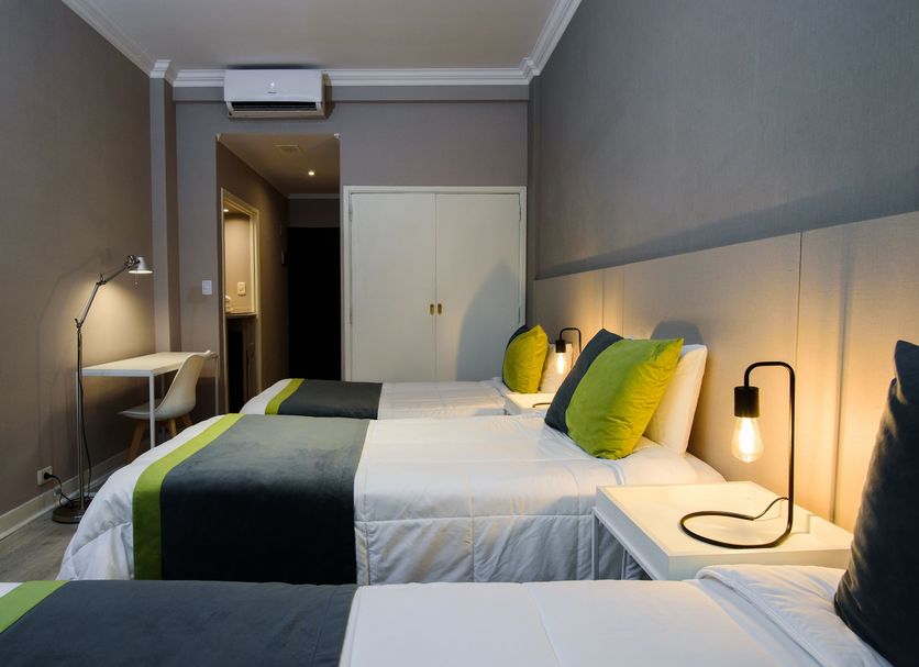 Suma Recoleta Hotel in Buenos Aires guest room with two twin beds, bedside lamps, and a small desk