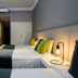 Suma Recoleta Hotel in Buenos Aires guest room with two twin beds, bedside lamps, and a small desk