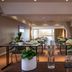 Hotel Du Port in Nogent-sur-Marne dining room with set tables and large window view