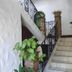 Hotel Casa Vieja in Puerto Escondido: interior stairway with wrought iron railing and potted plants