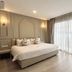 Eurana Boutique Hotel, Chiang Mai guest room with king bed and floor-to-ceiling window