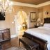 Belle View Manor Inn Harbour Grace guest room with ornate wood bed, chandelier, and sitting area