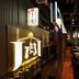 Meet Inn Narita in Narita: a stylish restaurant/bar area with glowing signage, stools, and grill tables