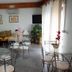 Piccolo Lamezia Terme lounge with glass tables, metal chairs, sofas, wall art and potted plants
