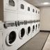 Canal Street New Orleans hotel laundry room with washers, dryers and bar stools