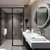 Mercure Chandigarh Tribune Chowk bathroom with walk-in shower, sink, and round mirror in Chandigarh