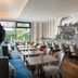Leonardo Hotel Vienna Hauptbahnhof dining area with tables, chairs, and striped walls in Vienna