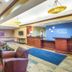 Holiday Inn Express & Suites Helena lobby with seating area, front desk and blue accent wall in Helena