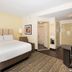 Candlewood Suites Ft Walton Bch - Hurlburt Area By IHG guest room with king bed and sitting area in Fort Walton Beach