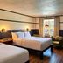 High Country Motor Lodge, Flagstaff guest room with two beds, wood floors, and seating by a window