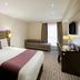 Premier Inn Nottingham Arena - London Road guest room with king bed, sofa bed, desk and wall-mounted TV in Nottingham