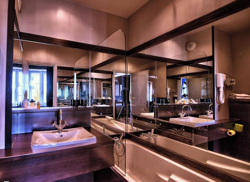 Hôtel des Beaux-Arts Toulouse bathroom with glass shower, sink and mirrored vanity