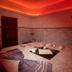 Latanya Park Resort Bodrum spa room with red ambient lighting and a massage table