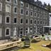 Achat Hotel Monschau stone façade with outdoor garden seating and playground in Monschau