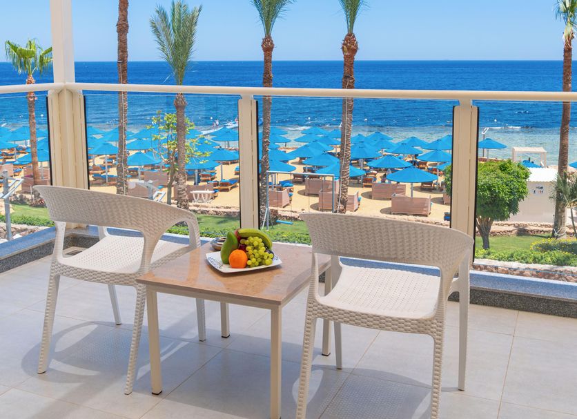 Balcony sea view at Pickalbatros Royal Grand Sharm in Sharm el-Sheikh with chairs and oceanfront pools