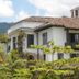 El Refugio Hotel & Spa in Sasaima, white villa with tiled roof, balconies, and lush garden