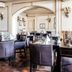 Fletcher Hotel-Restaurant La Ville Blanche dining room in Thorn with set tables and arched doorway