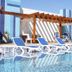 Gran Bourbon Hotel Asuncion in Asuncion: rooftop pool with blue lounge chairs and pergola shade