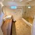 El Mosquito Boutique Hotel Playa Bonita bathroom with stone shower, wood vanity and marble floor in Las Terrenas